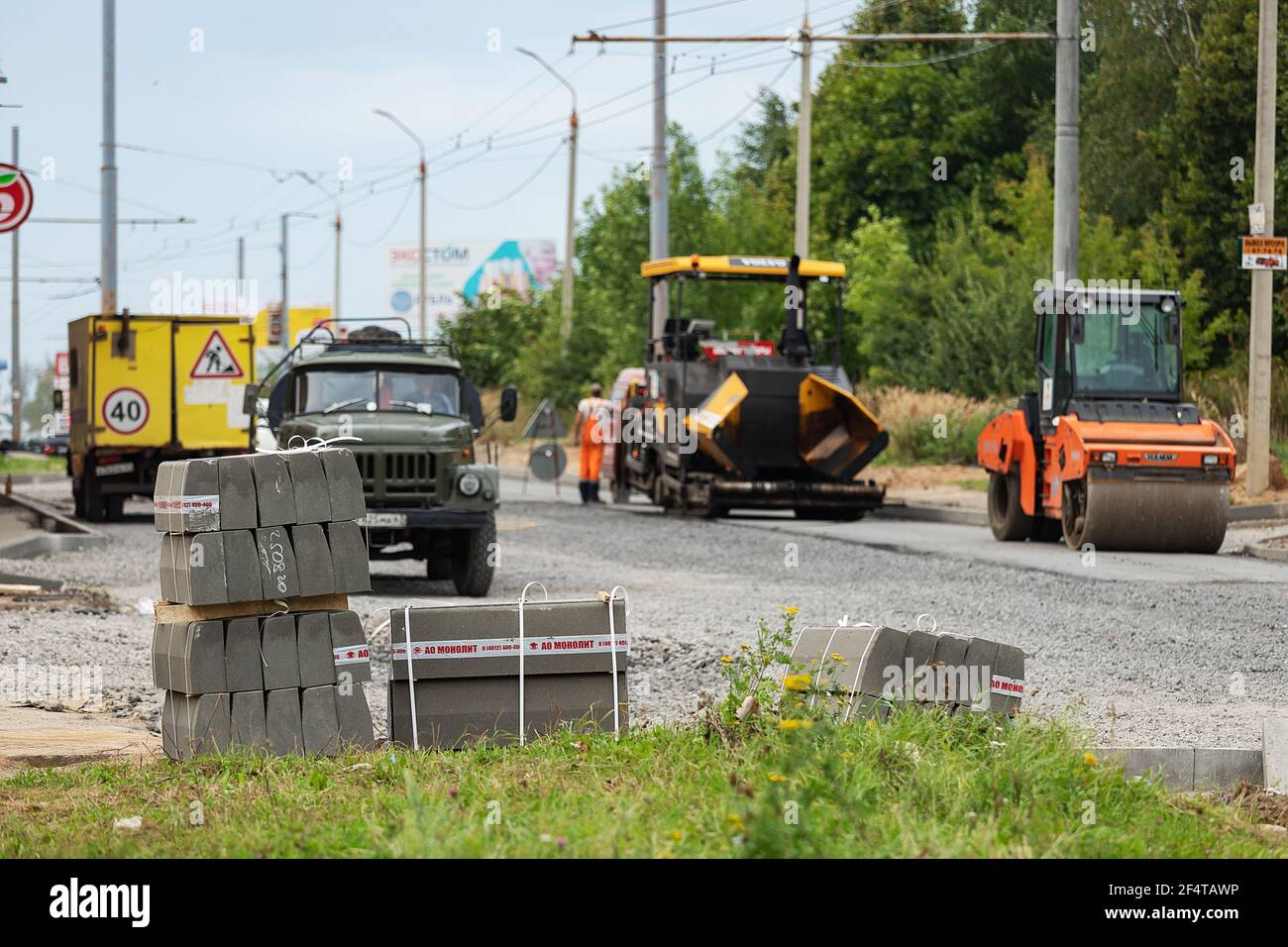poorly executed road repairs. replacing the old curb stone with a new one Stock Photo