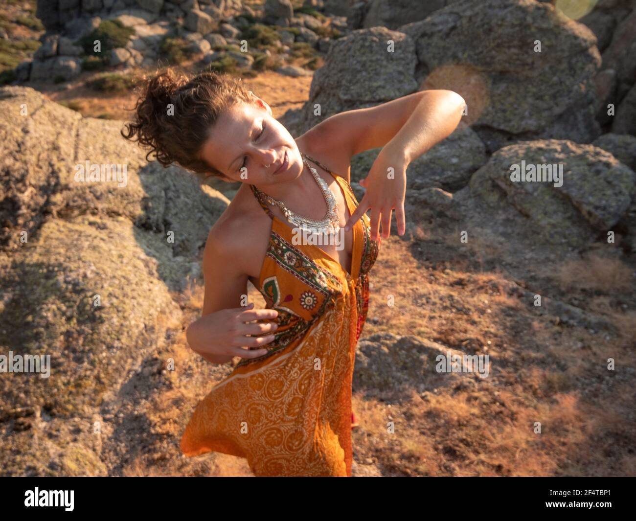 Woman dancing for her self in the sunset. Stock Photo