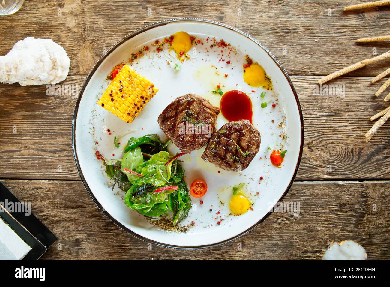 Grilled fillet mignon steaks with corn and salad Stock Photo