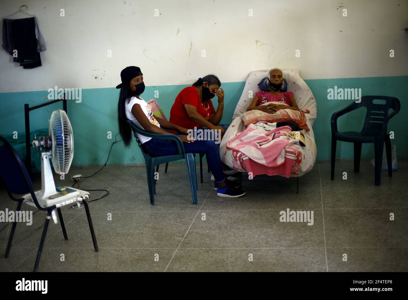 Valencia, Carabobo, Venezuela. 22nd Mar, 2021. March 23, 2021. Andrea Paredes (R), 74 years old, remain in bed awaiting medical attention, with a health situation of reserved prognosis. Photo: Juan Carlos Hernandez Credit: Juan Carlos Hernandez/ZUMA Wire/Alamy Live News Stock Photo