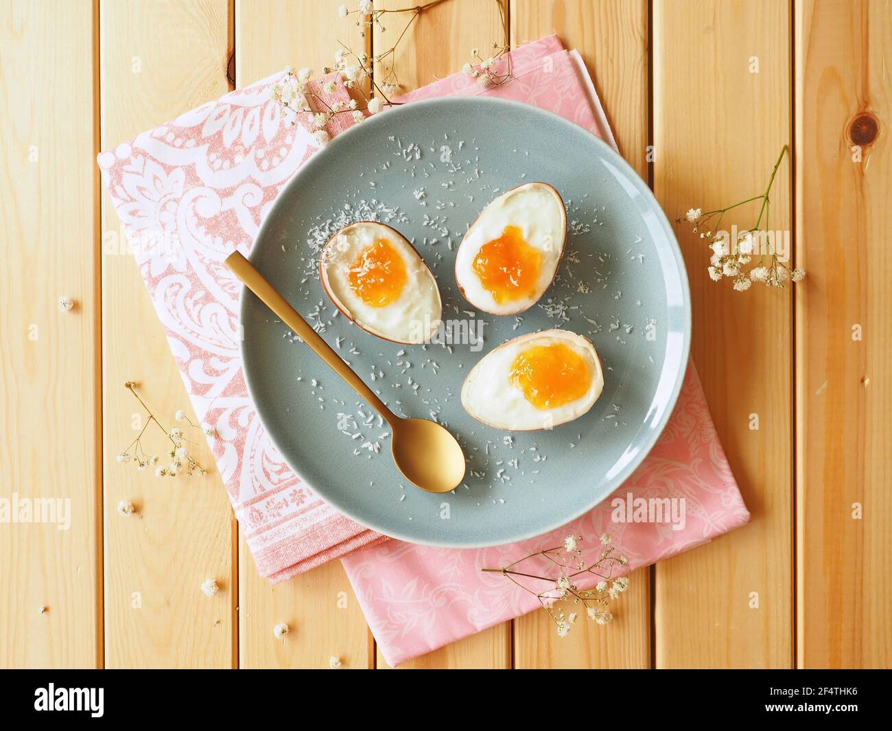 Chocolate eggs with yogurt and orange jam on rustic wooden table Stock Photo