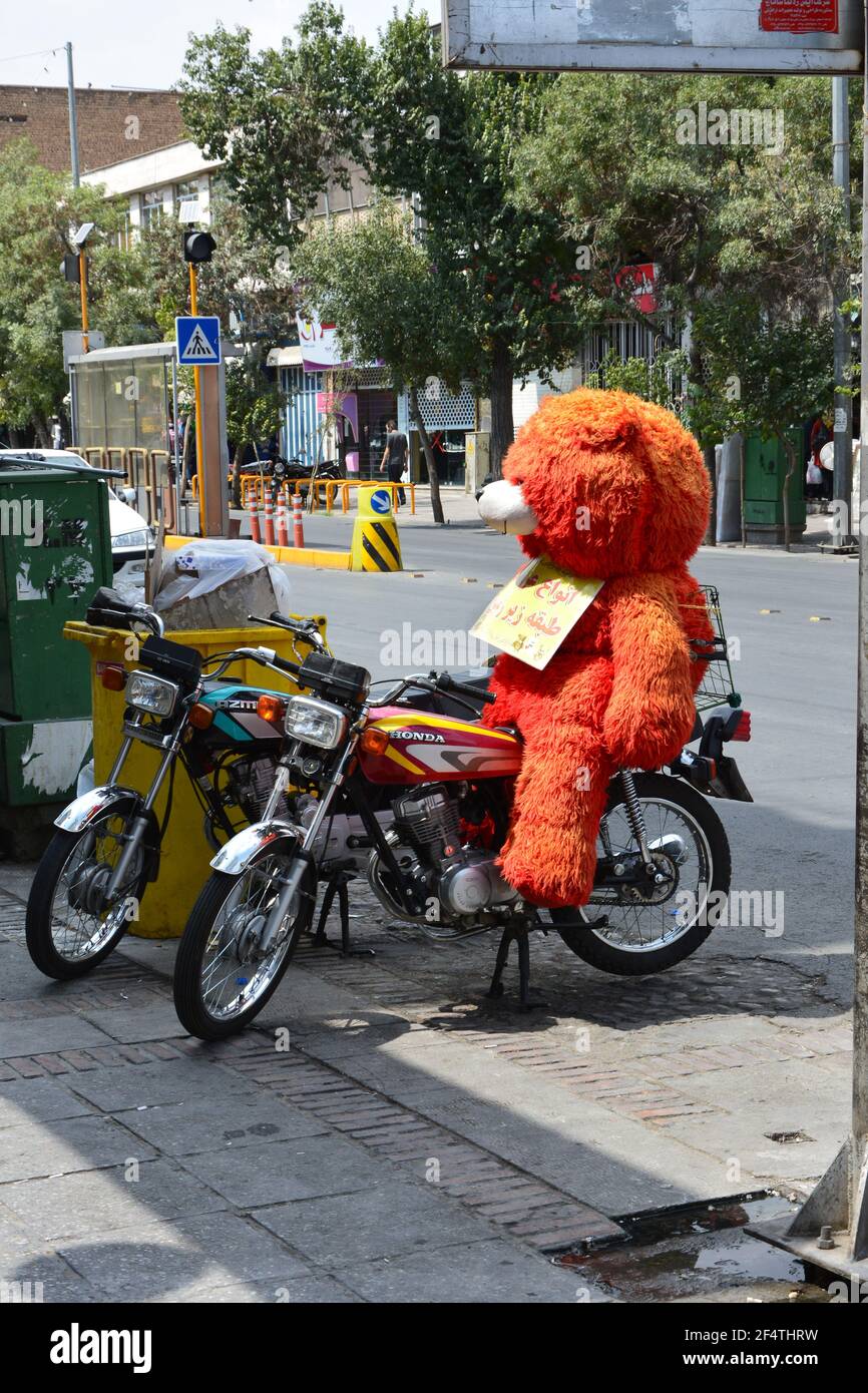 A huge teddy bear on a parked motorcycle in Shiraz Iran Stock Photo Alamy