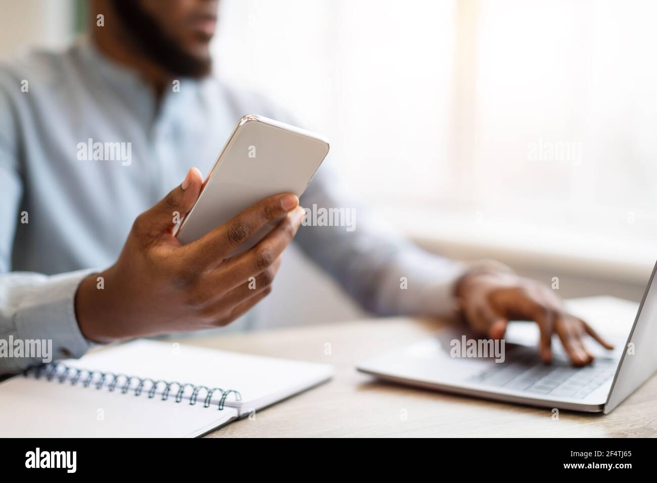 African businessman using smartphone laptop hi-res stock photography ...