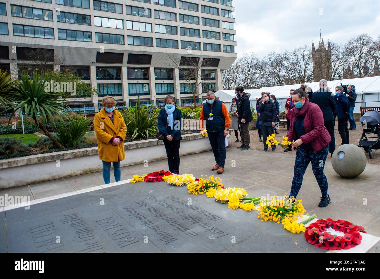 Lonon, UK. 23rd Mar, 2021. Those who have suffered from coronavirus remembered on one year lockdown anniversary with one minute silence at St Thomas hospital opposite the Houses of Parliament. Held at the statue of Mary Seacole on Westminster Bridge. 126000 people have so far died from the virus.  Credit: JOHNNY ARMSTEAD/Alamy Live News Stock Photo