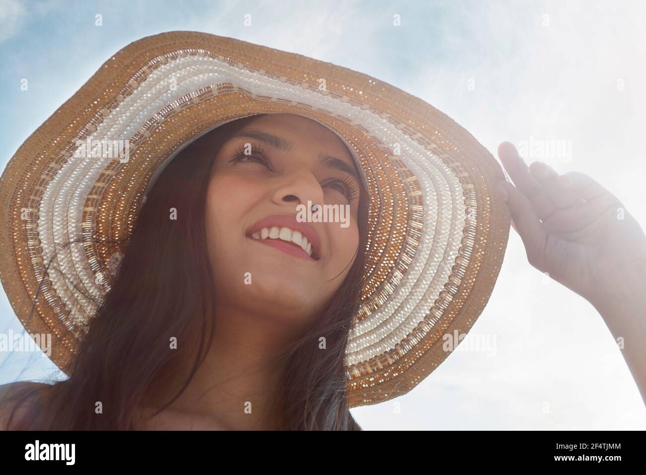 A YOUNG HAPPY WOMAN ENJOYING A HOT SUNNY DAY Stock Photo