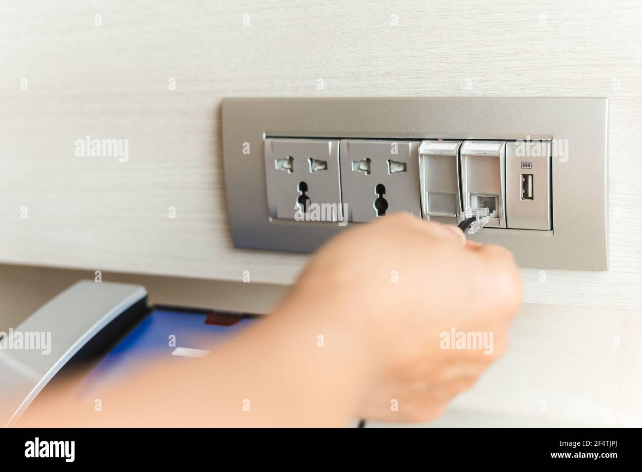 Hand plug in cable wire into extender device socket on the