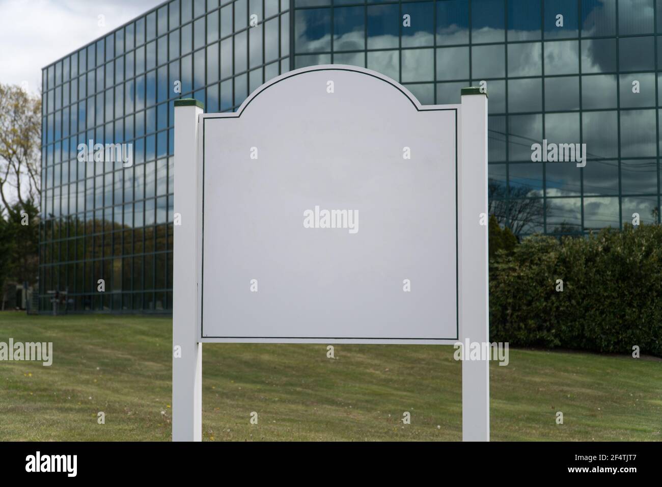 Blank sign outside generic glass office building. Typical exterior ...