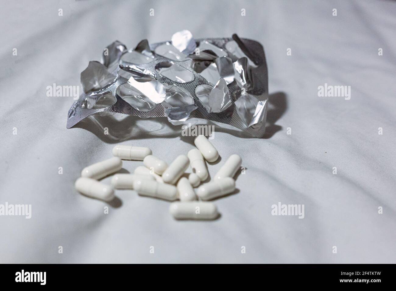 Close up of pain pills and an empty blister pack. Overdose, suicide, depression concept Stock Photo