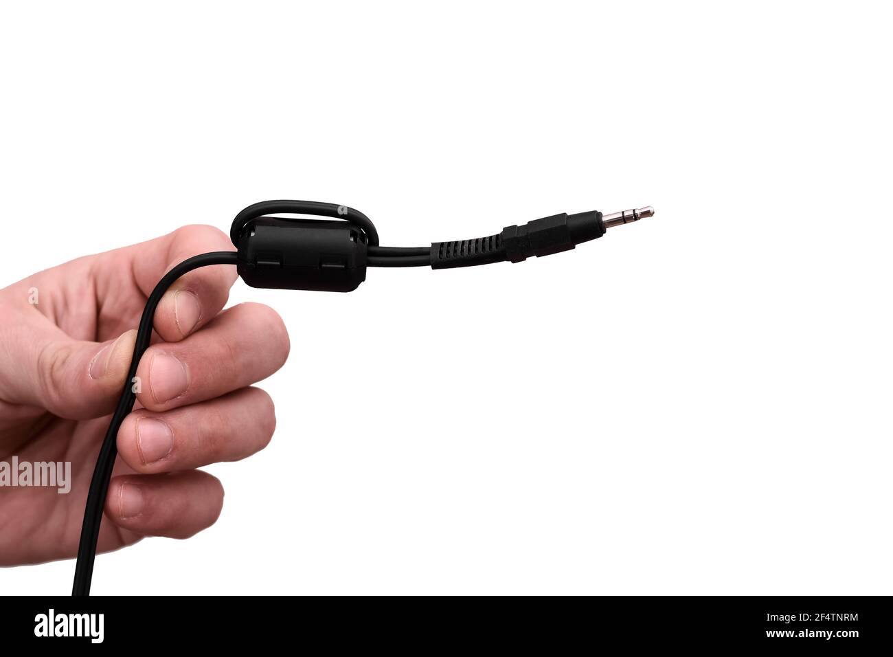 Close-up Jack plug and a cable. in the hands of a man on the white background.  Stock Photo