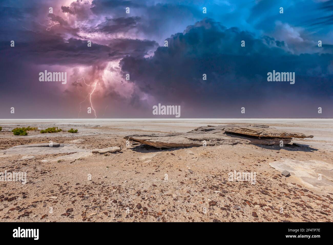Heavy thunderstorm with bright white purple lightning over Kati Thanda – Lake Eyre in the deserts of central Australia just in Northern South Australi Stock Photo