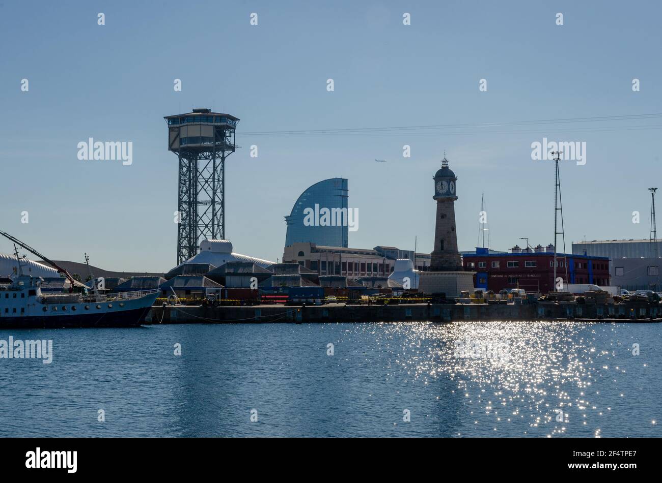 Port of Barcelona and cable car tower against clear blue sky, Catalonia ...