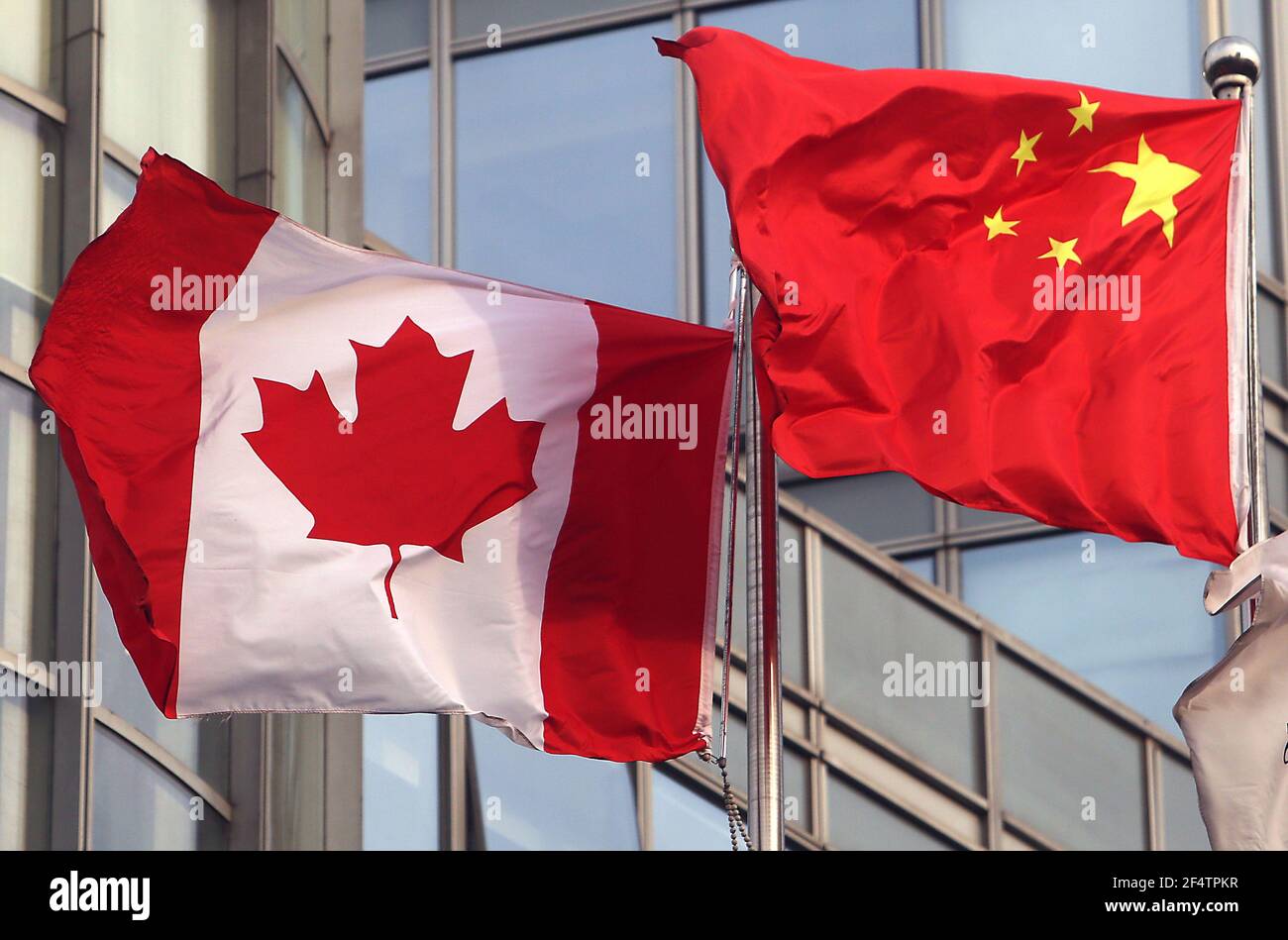 Beijing, China. 23rd Mar, 2021. Canada's national flag flies next to China's flag outside an international hotel down the road from the Canadian Embassy in Beijing on Tuesday, March 23, 2021. After more than two years in detention, former Canadian diplomat Michale Kovrig was put on trial in the capital for espionage in a case criticized by diplomats and international legal experts as an exercise in hostage diplomacy and for contravening international law. Photo by Stephen Shaver/UPI Credit: UPI/Alamy Live News Stock Photo