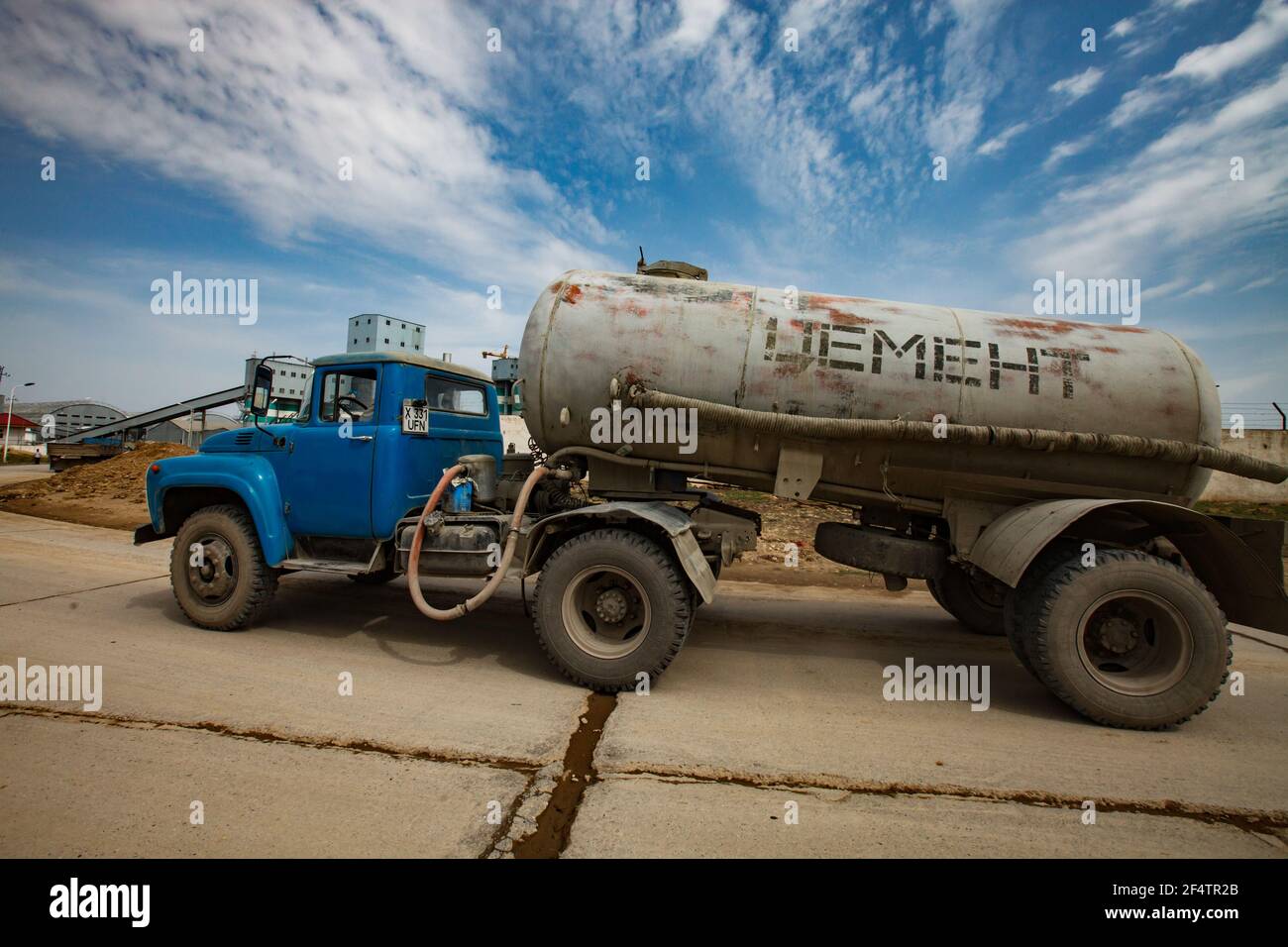 Standard Cement plant. Truck with dry cement on blue sky background