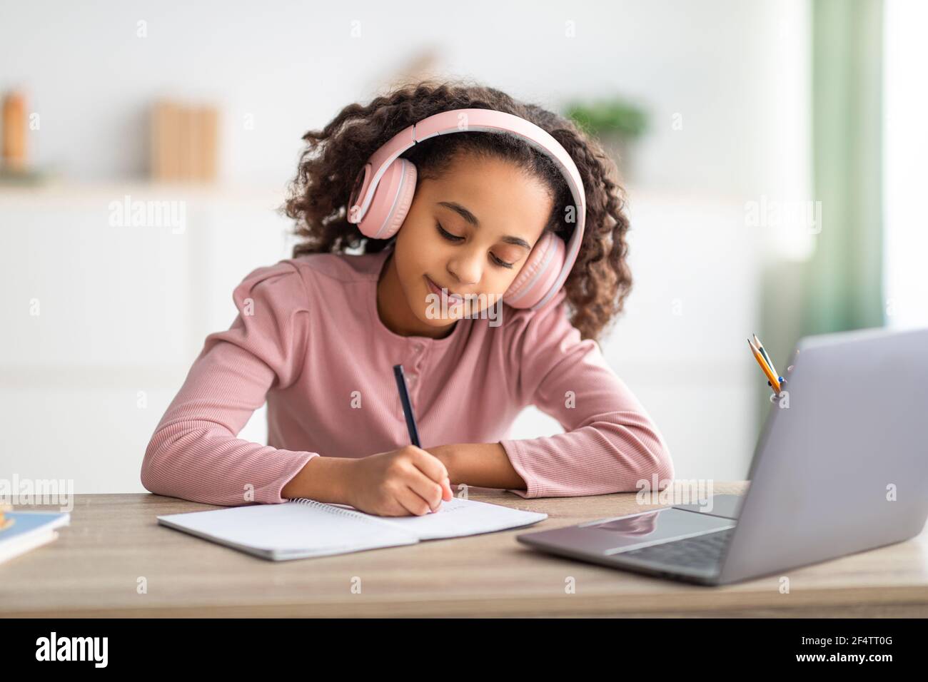 African american schoolgirl having online lesson, using laptop and ...
