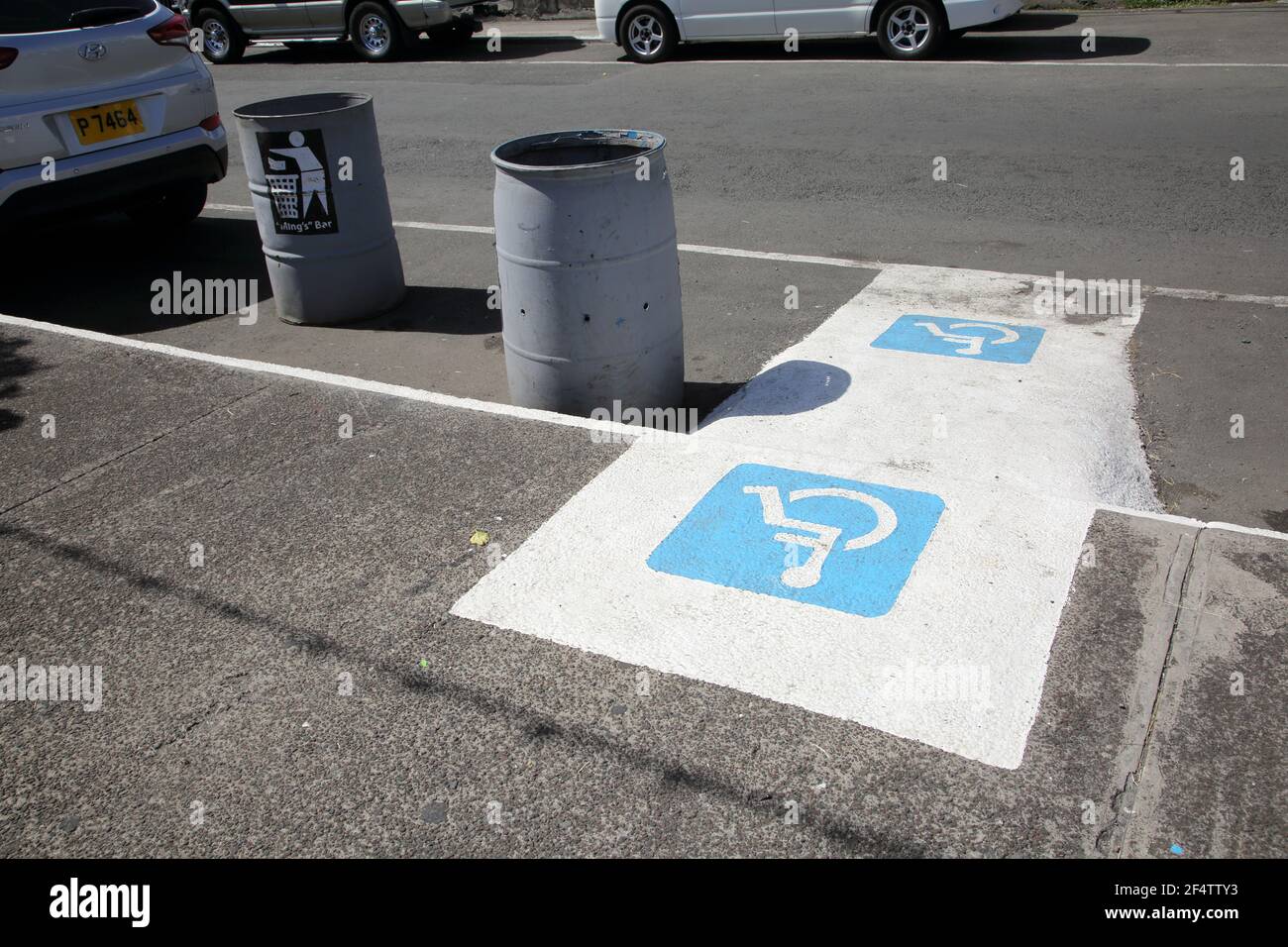 St George's Grenada Disabled Parking Bay and Trash Cans Stock Photo