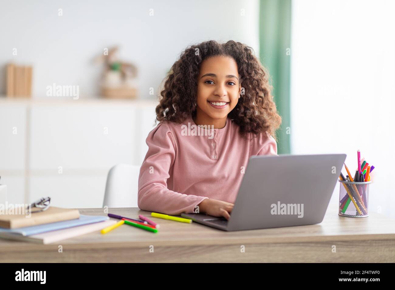 E-Learning. African american girl studying on laptop computer learning ...