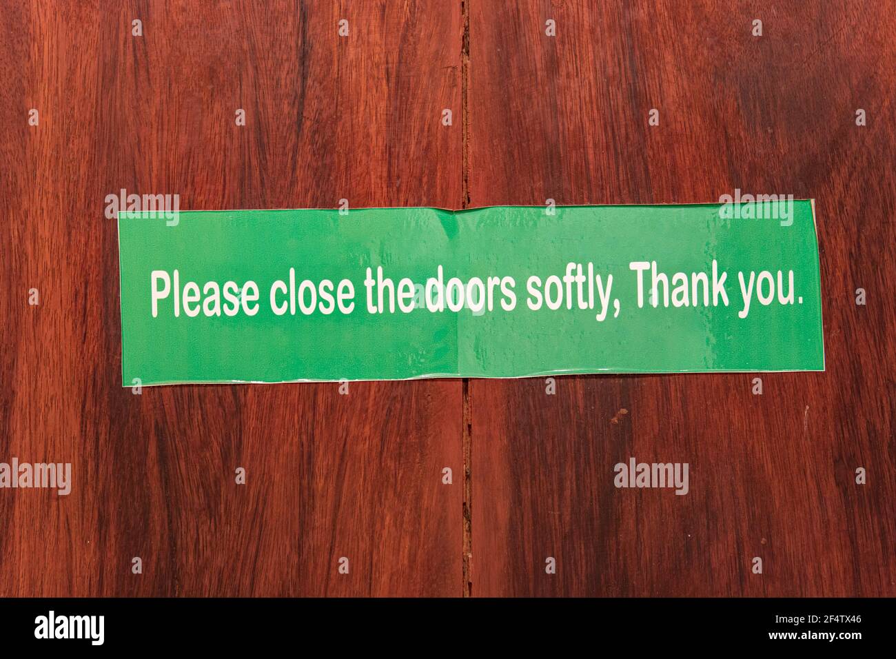 The instruction inscription for carefully close the door in the hotel room- Stock Photo