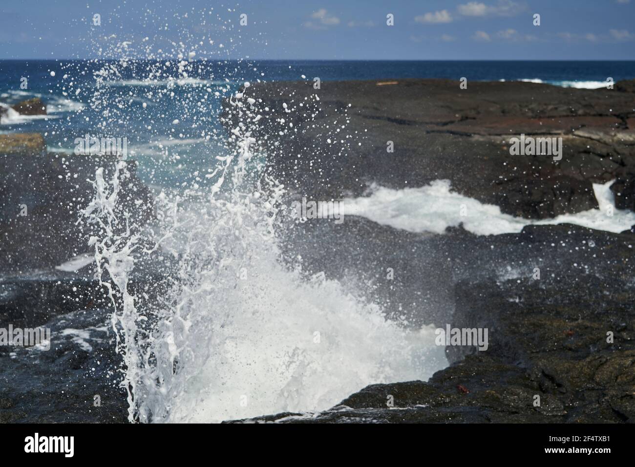 waves crushing over lava rocks on the shoreline of the galapagos
