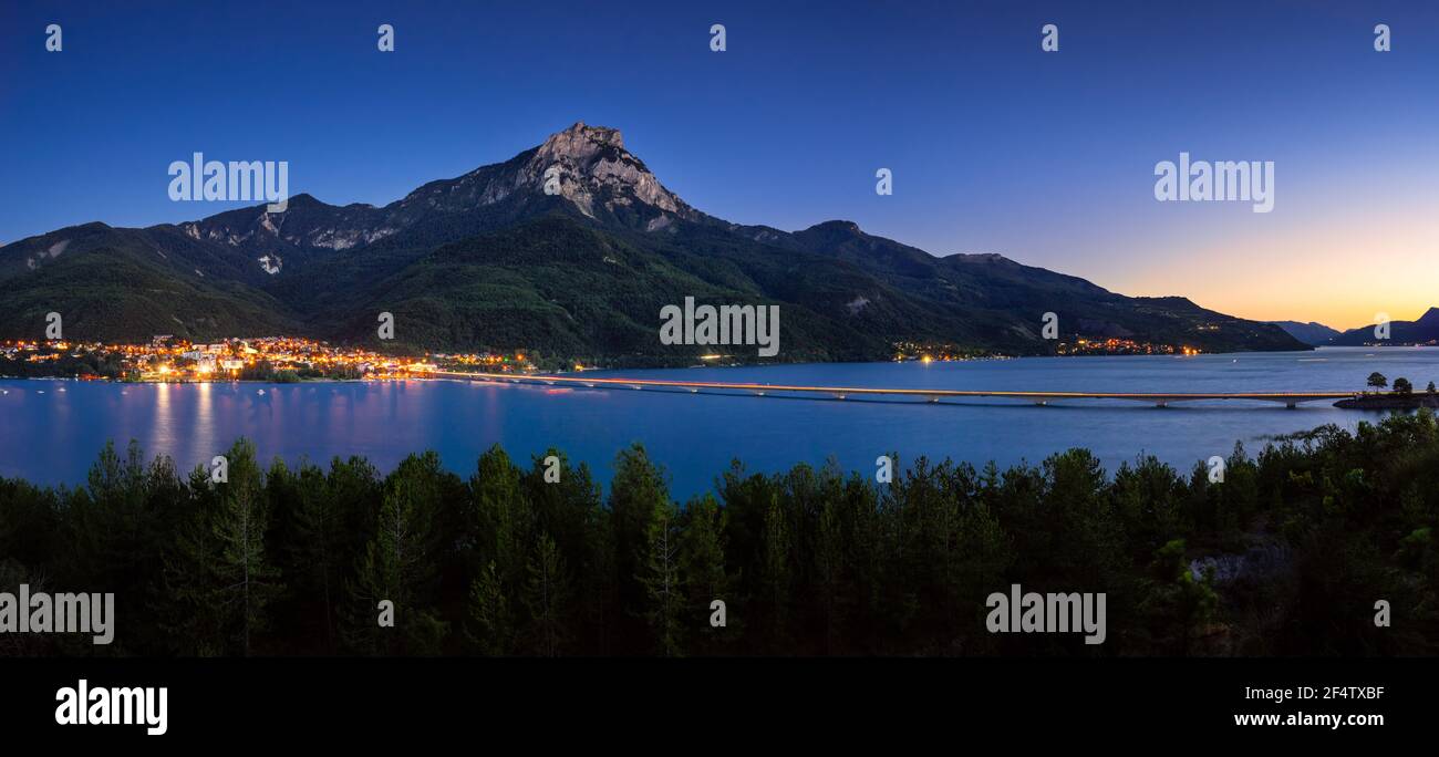 The village of Savines-le-Lac and Serre-Poncon Lake in summer with Grand Morgon Peak at twilight. Hautes-Alpes, Alps, France Stock Photo