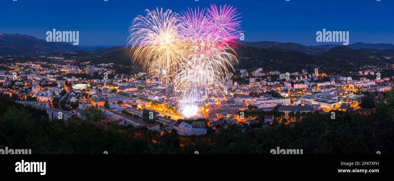 The city of Gap with July 14th Fireworks (Bastille Day celebration) in the Hautes-Alpes in Summer at twilight. Hautes-Alpes, France Stock Photo