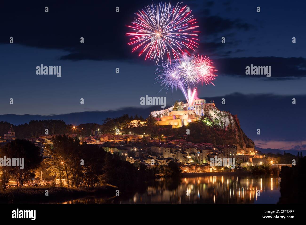 Sisteron with 14th of July fireworks (Bastille Day celebration) over the Citadel at twilight. Durance Valley, Alpes-de-Haute-Provence, France Stock Photo