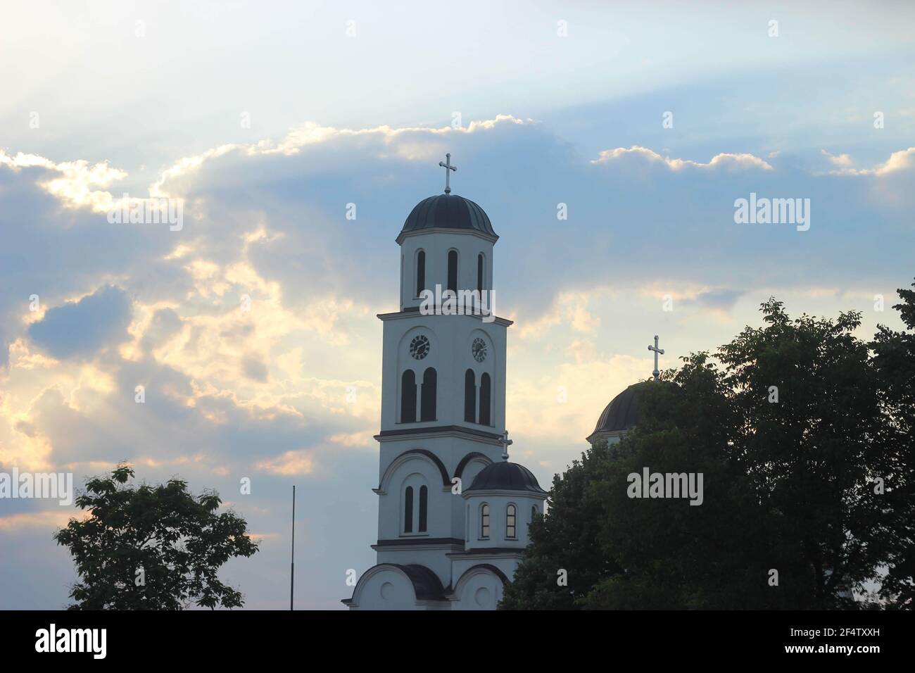 Church under a beautiful cloudy sky at golden hour Stock Photo - Alamy