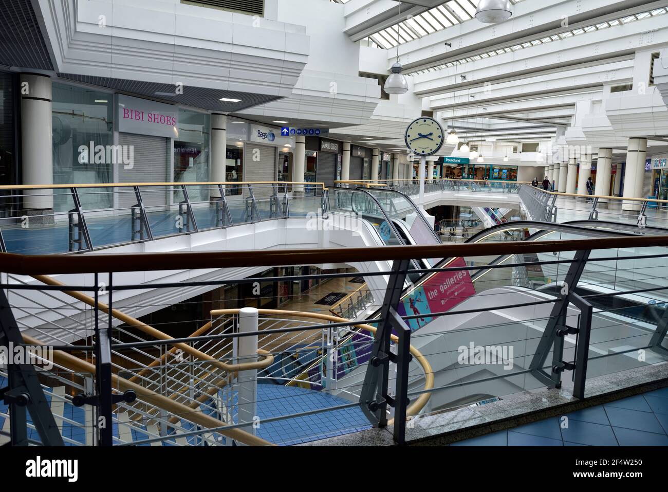Inside large normally busy shopping centre nearly empty mid afternoon weekend with shops closed during lockdown due to Covid-19 pandemic, UK Stock Photo