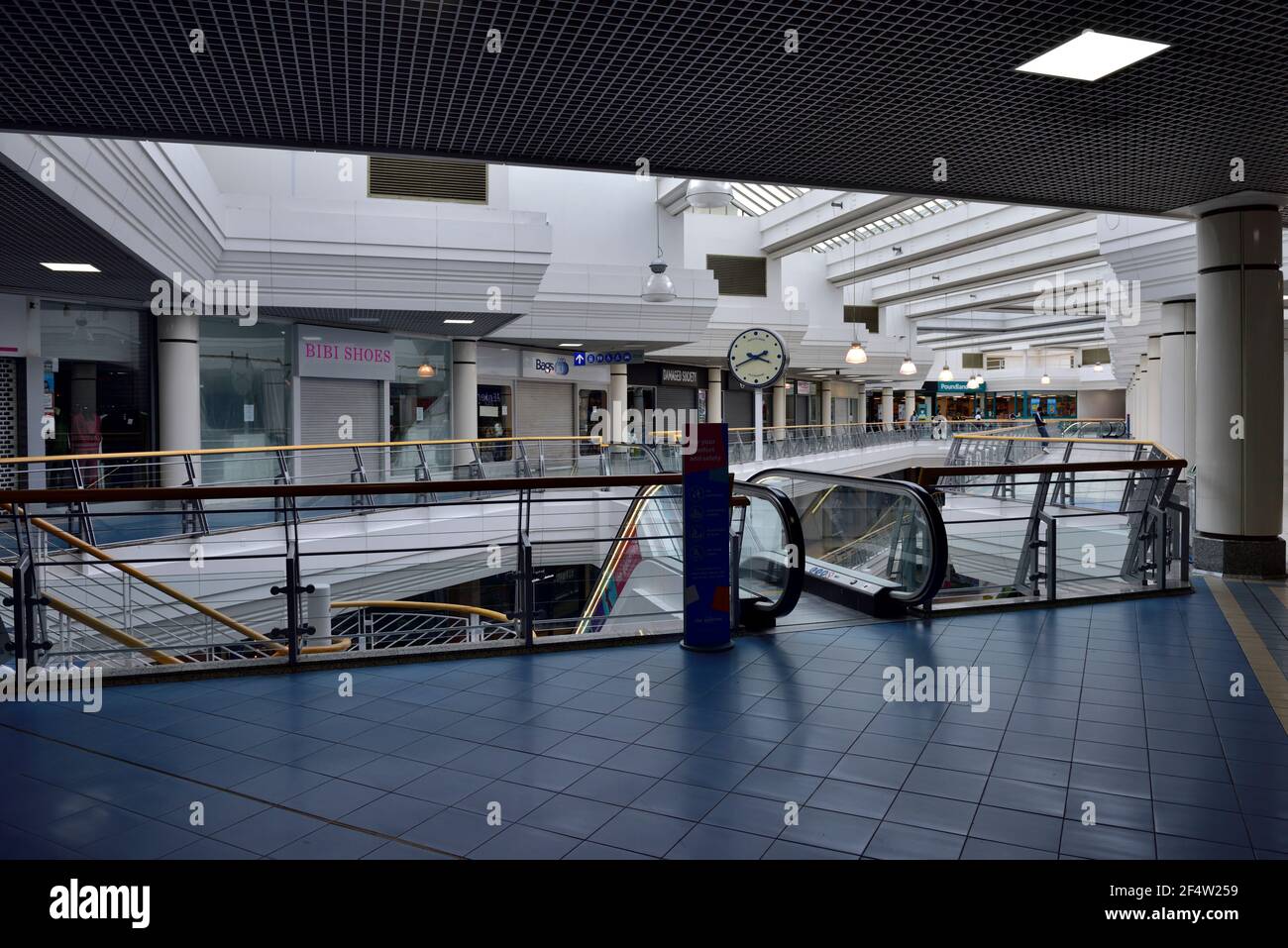 Inside large normally busy shopping centre nearly empty mid afternoon weekend with shops closed during lockdown due to Covid-19 pandemic, UK Stock Photo