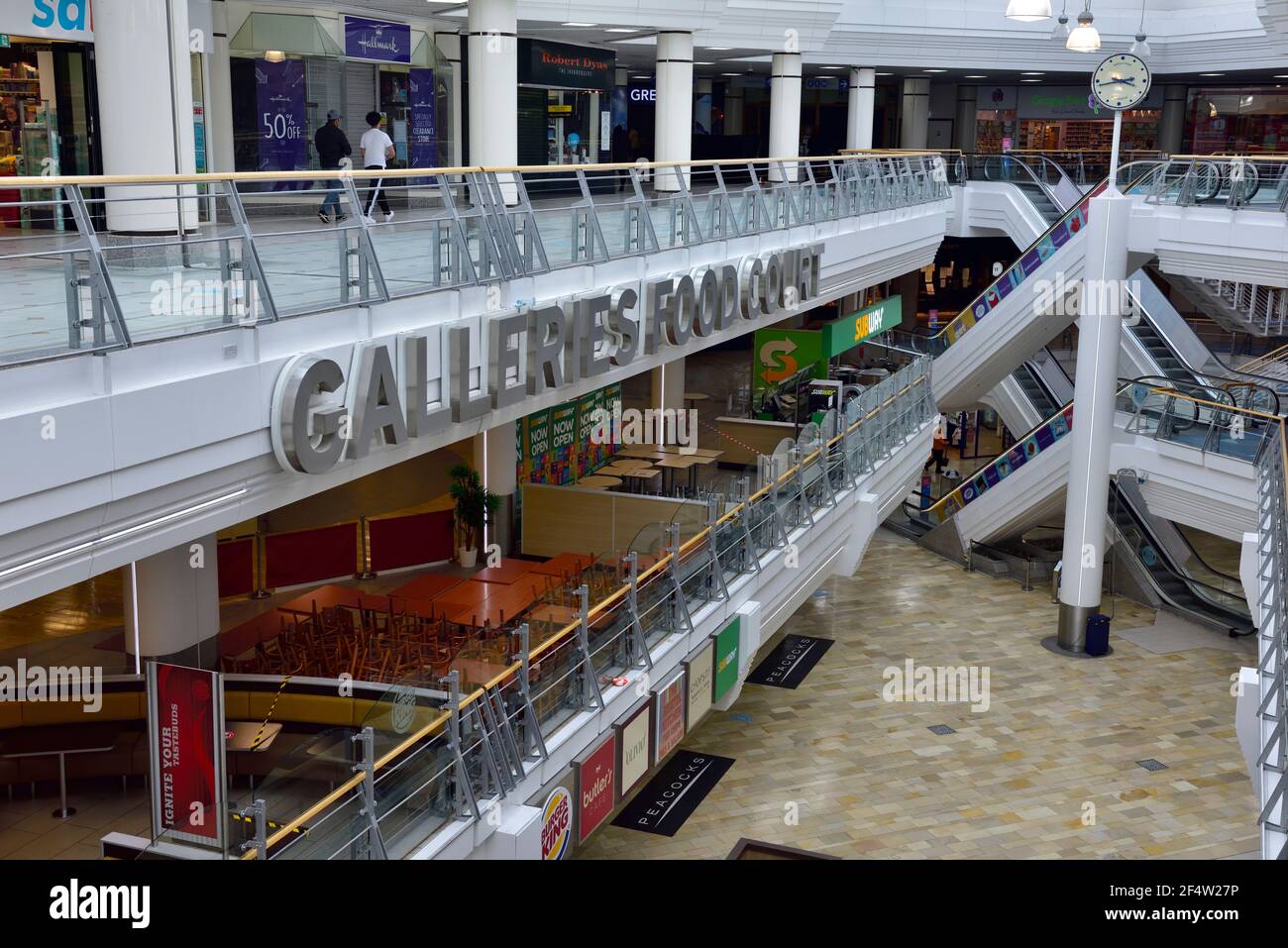 Inside large normally busy shopping centre nearly empty mid afternoon Saterday with shops  food court closed during lockdown due to Covid-19 pandemic, Stock Photo