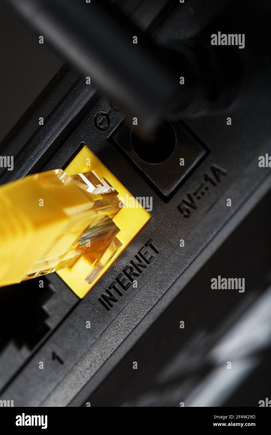 Wireless modem router with yellow cable and LAN port for connection on