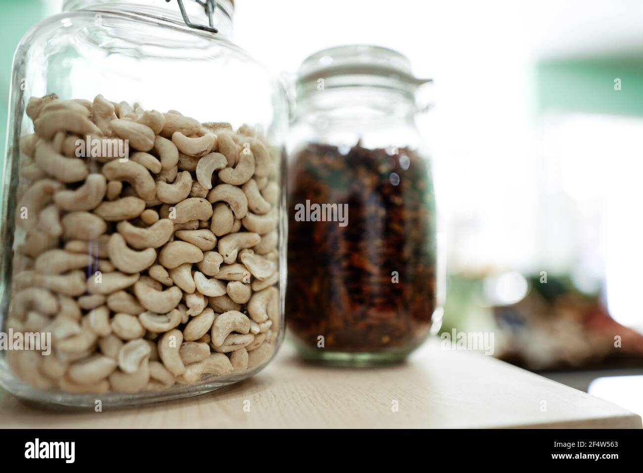 Glass jar with cashew nuts, dry chilli at a local organic marketplace Stock Photo