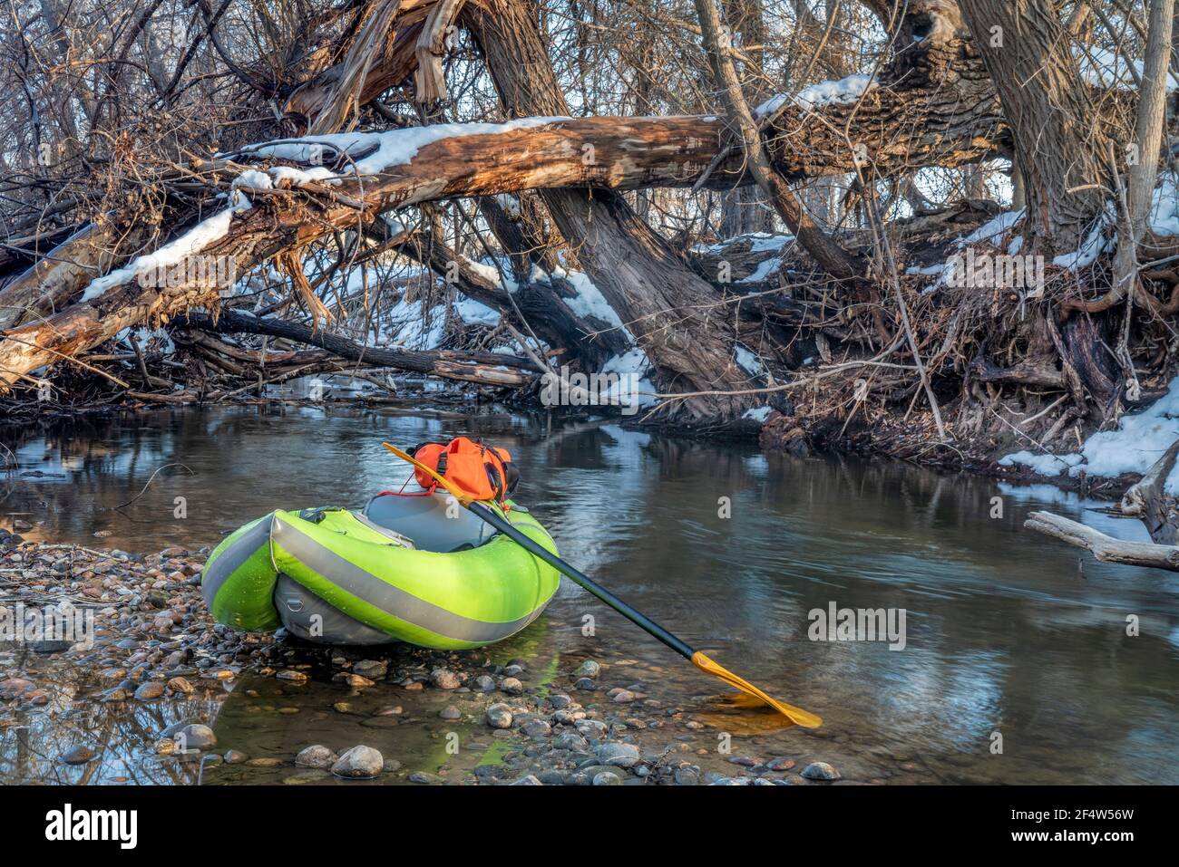 inflatable whitewater kayak at river log jam Poudre River in Fort