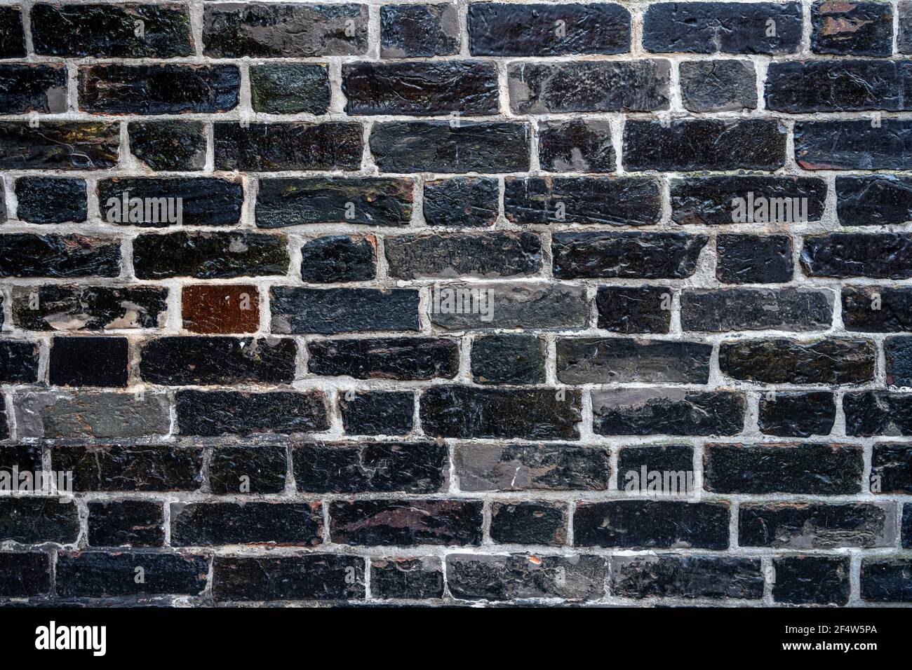 Background from a carbon black brick wall Stock Photo
