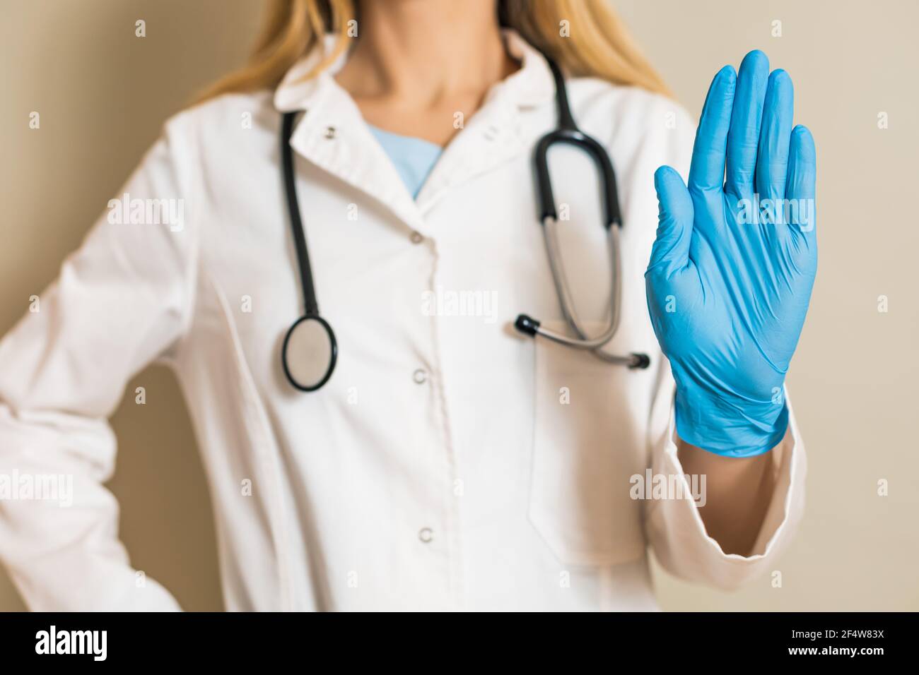Image of female doctor showing stop sign Stock Photo - Alamy