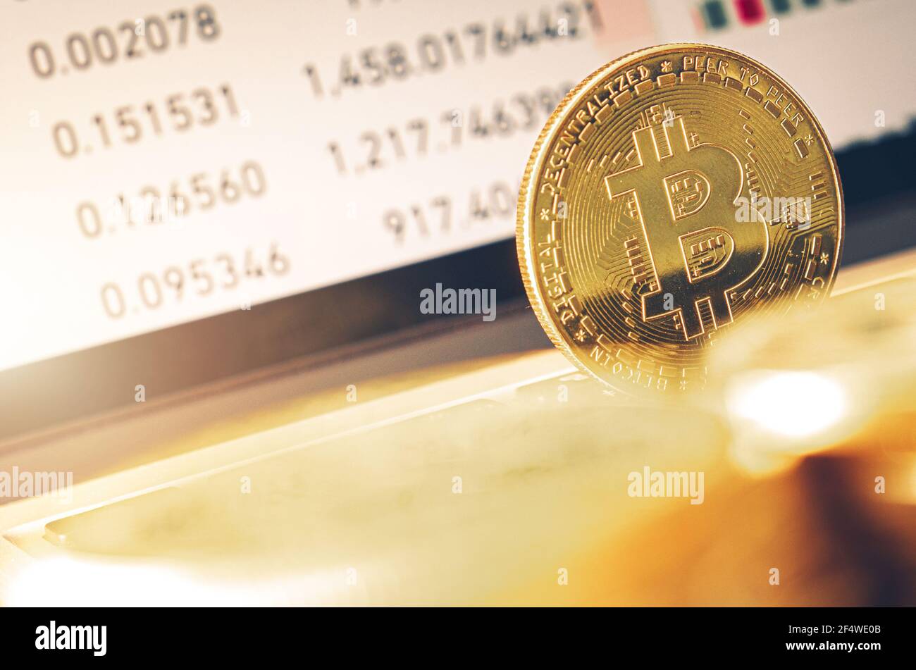 Golden BTC Bitcoin on Laptop Keyboard Close Up. Cryptocurrency Decentralized Financial Theme. Stock Photo