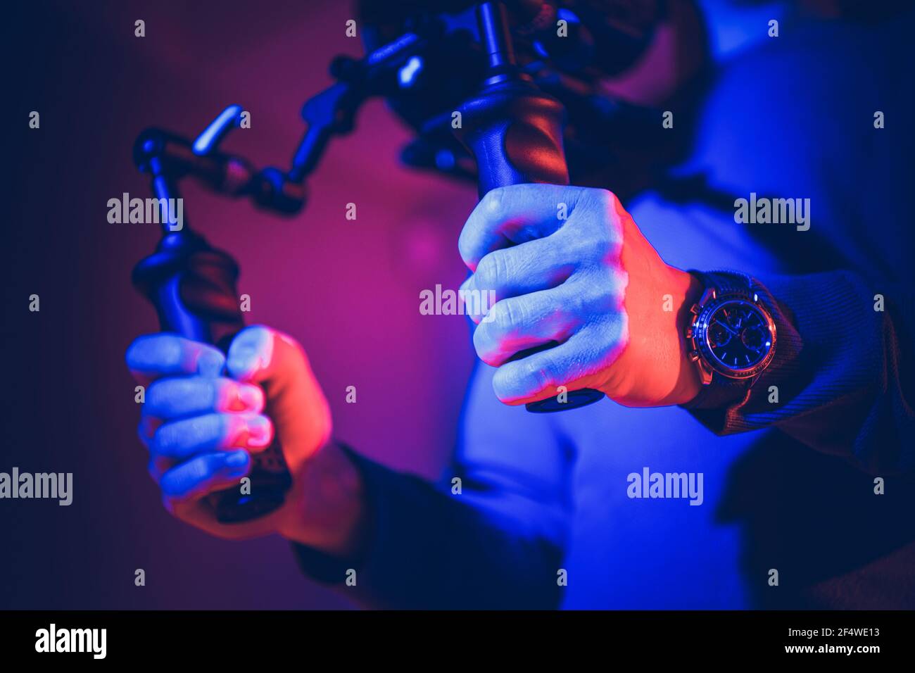 Handheld Digital Camera Image Stabilization System. Operator Keep Equipment in His Hands. Film and Videography Production Theme. Stock Photo