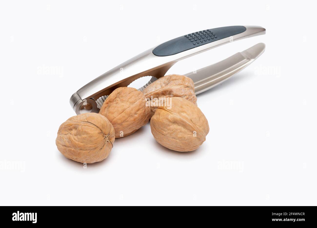 nutcracker and walnuts on white background Stock Photo