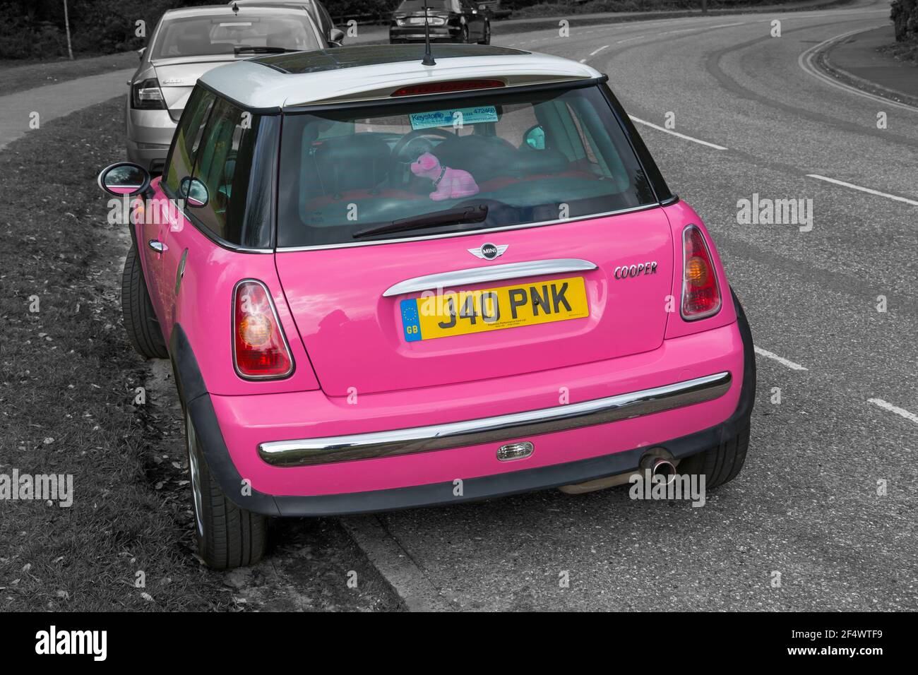 Pink Mini Cooper car with personalised number plate, registration plate, parked in road at Bournemouth, Dorset UK in March Stock Photo