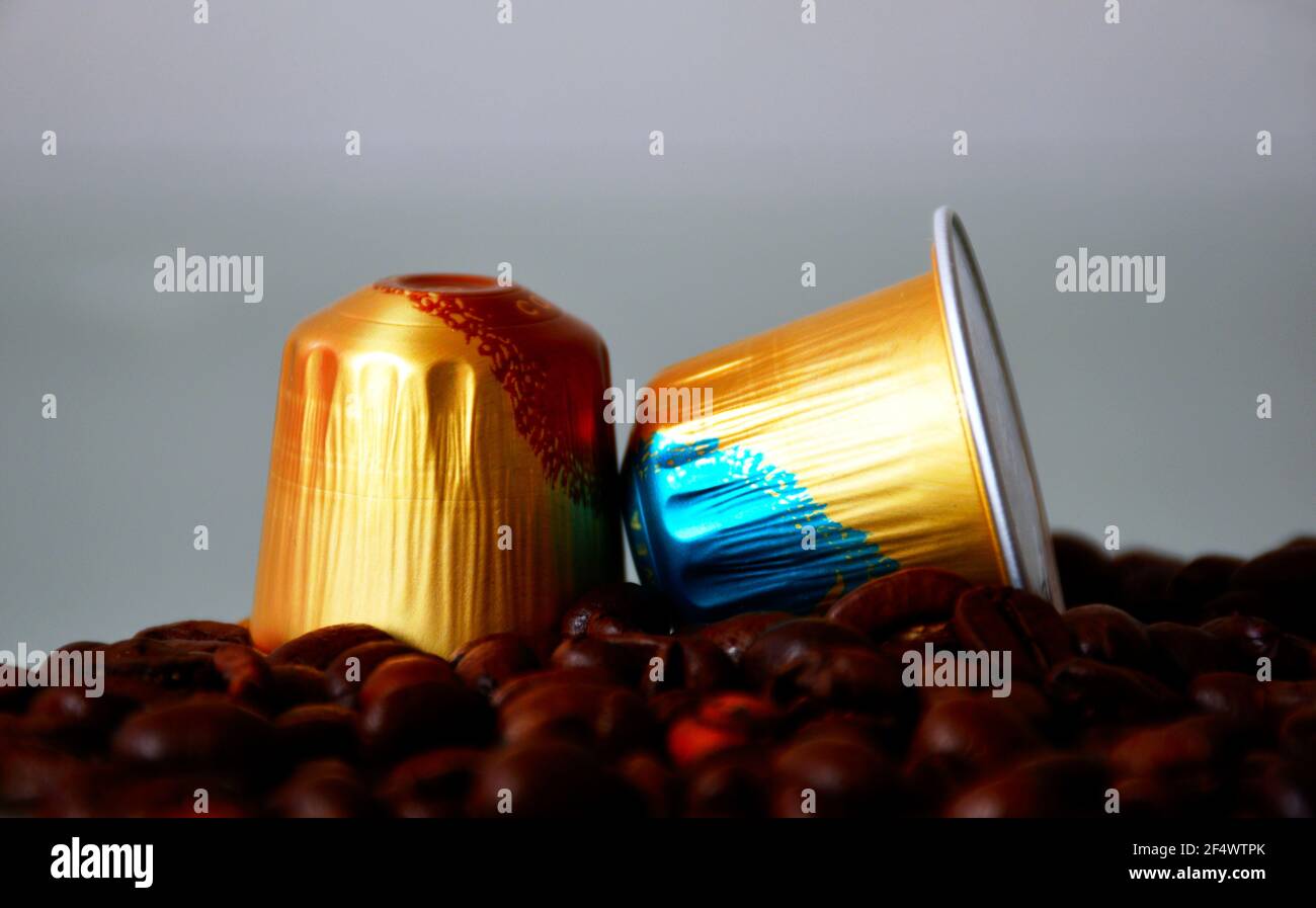 golden color aluminum coffee capsules. closeup view. coffee beans in