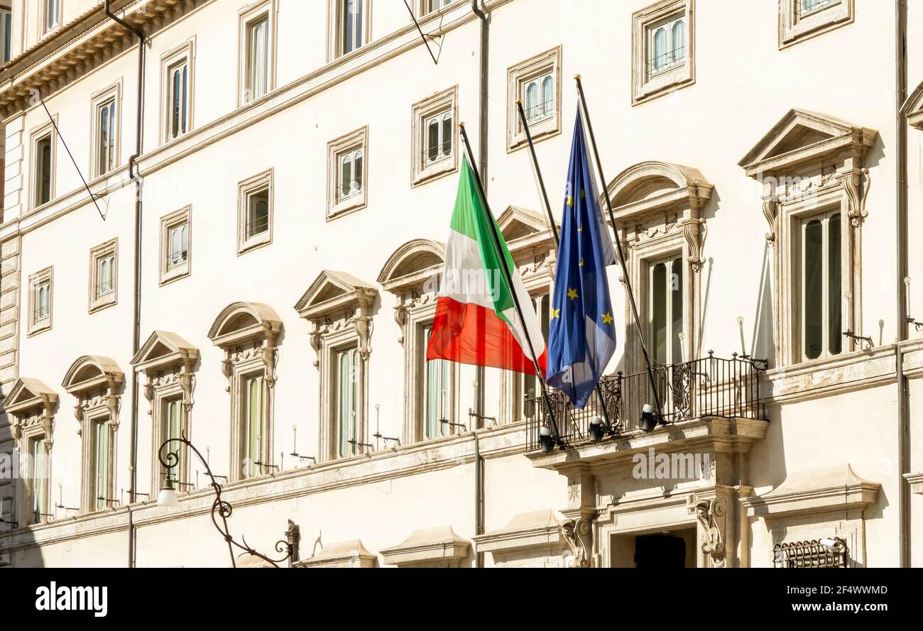 facade of Palazzo Chigi in Rome, seat of the Italian prime minister and government. The Italian and European flags on the balcony of the facade. Outdo Stock Photo