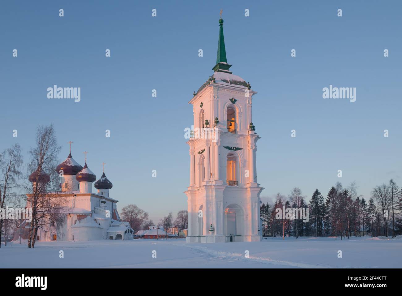 Ancient bell tower and Nativity Cathedral on Cathedral Square on February morning. Kargopol, Russia Stock Photo