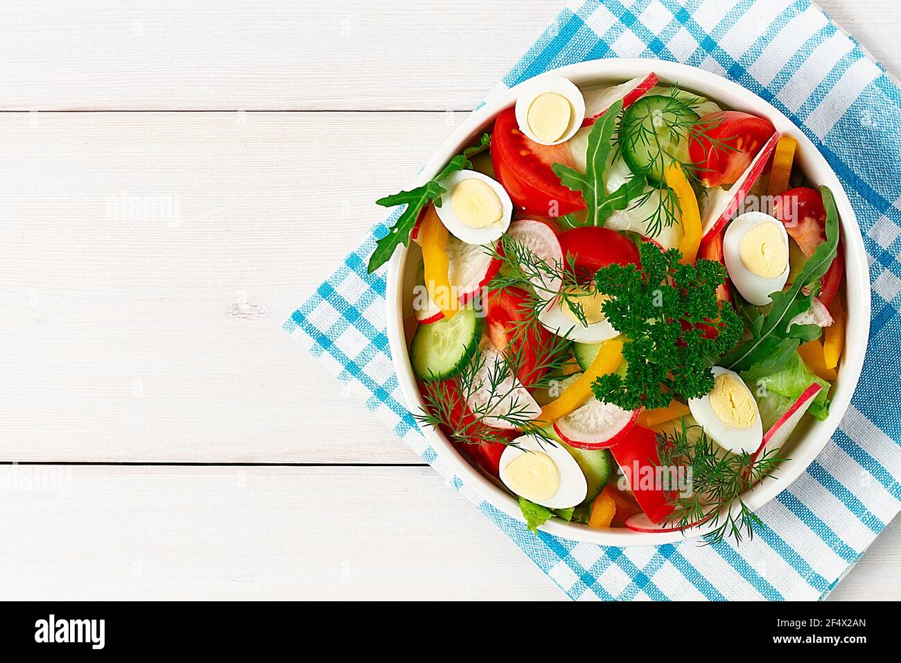 vegetable salad of tomato, cucumber, pepper , iceberg and quail eggs, on a white background, horizontal, Stock Photo