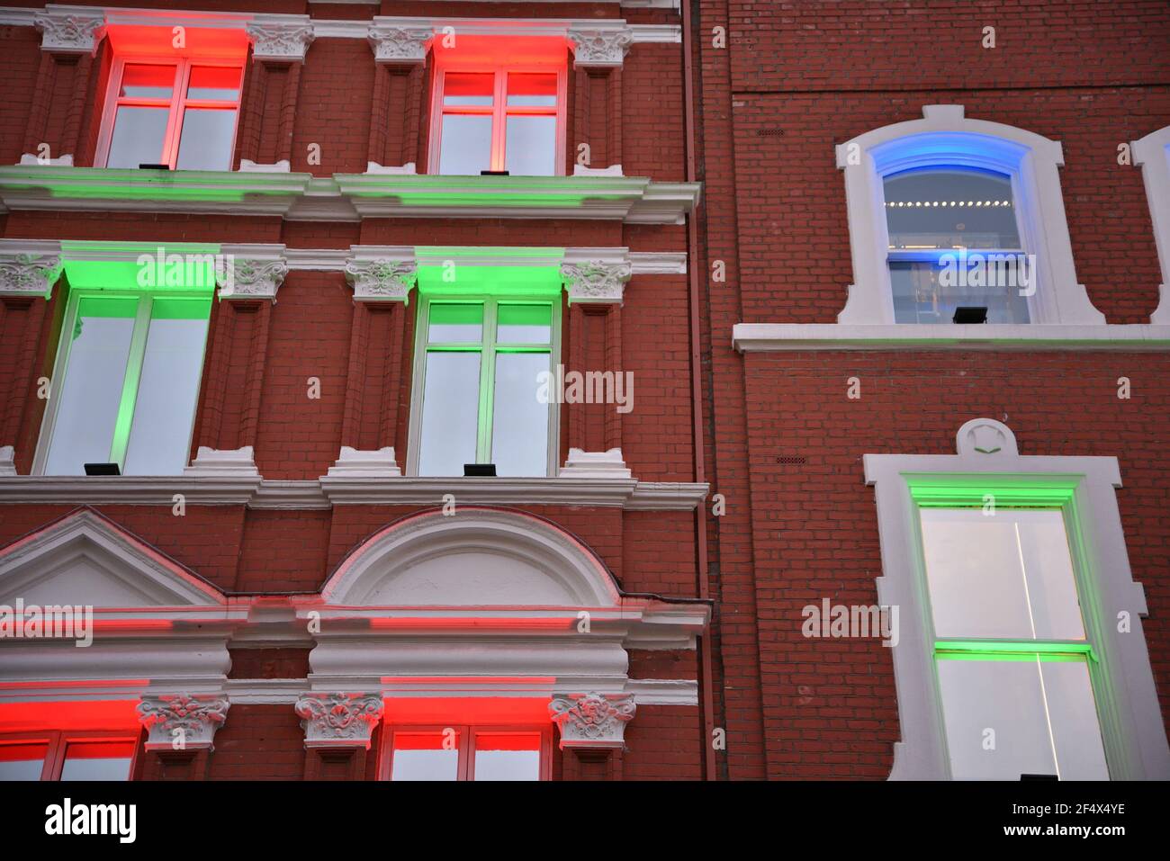 style building facade with red and green Christmas lights on