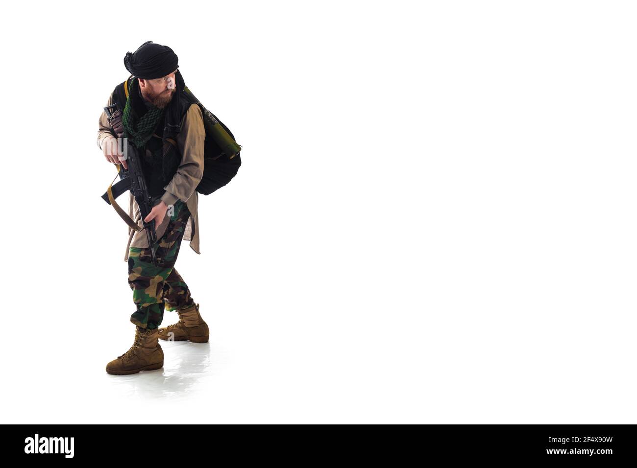 man in military outfit warrior Mujahedin in modern times on a white background in studio Stock Photo
