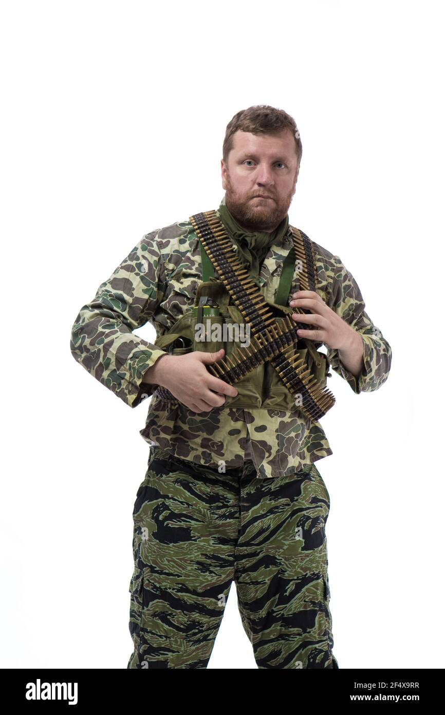 Man actor in the form of an American fur seal posing with a machine gun in his hands on a white background. Special Forces in Vietnam, 1970's. Stock Photo