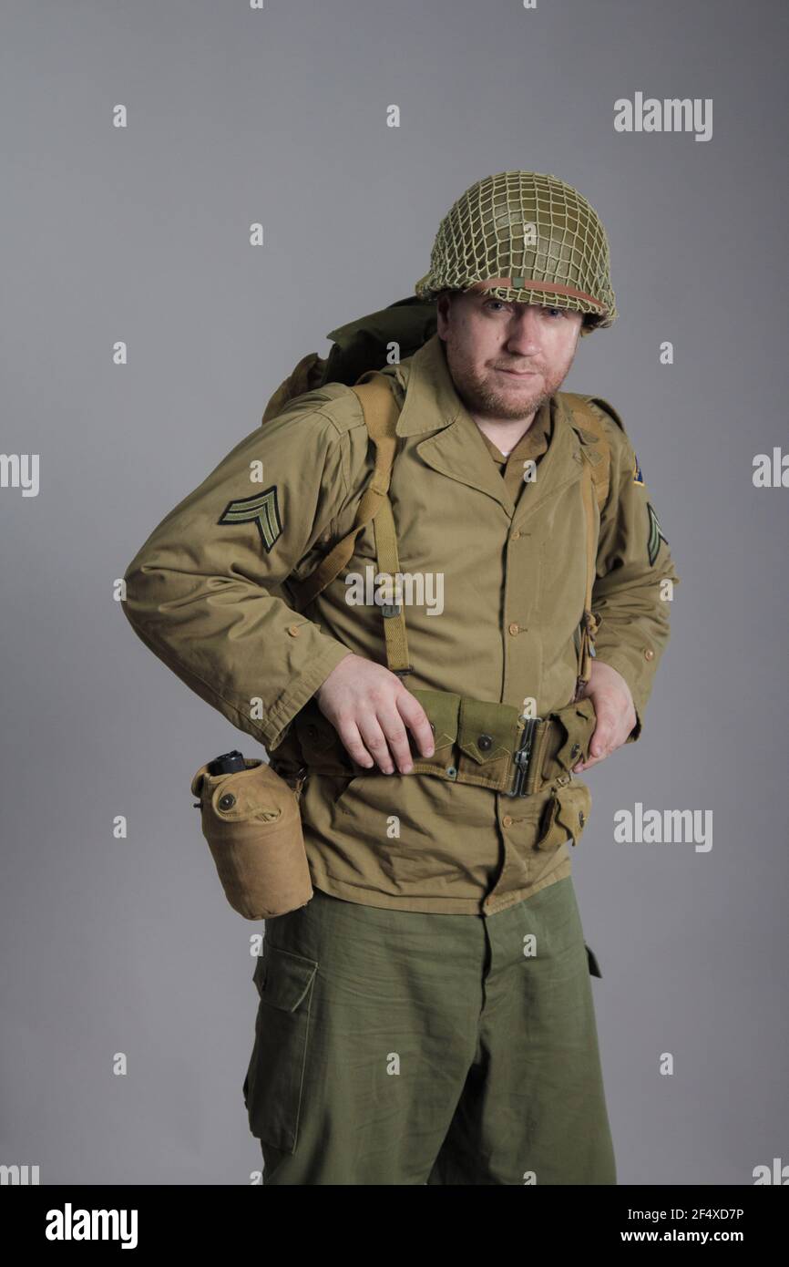 The man is an actor in the military uniform of an American ranger, wearing a helmet and with a carbine in his hands, the period of the Second World Wa Stock Photo