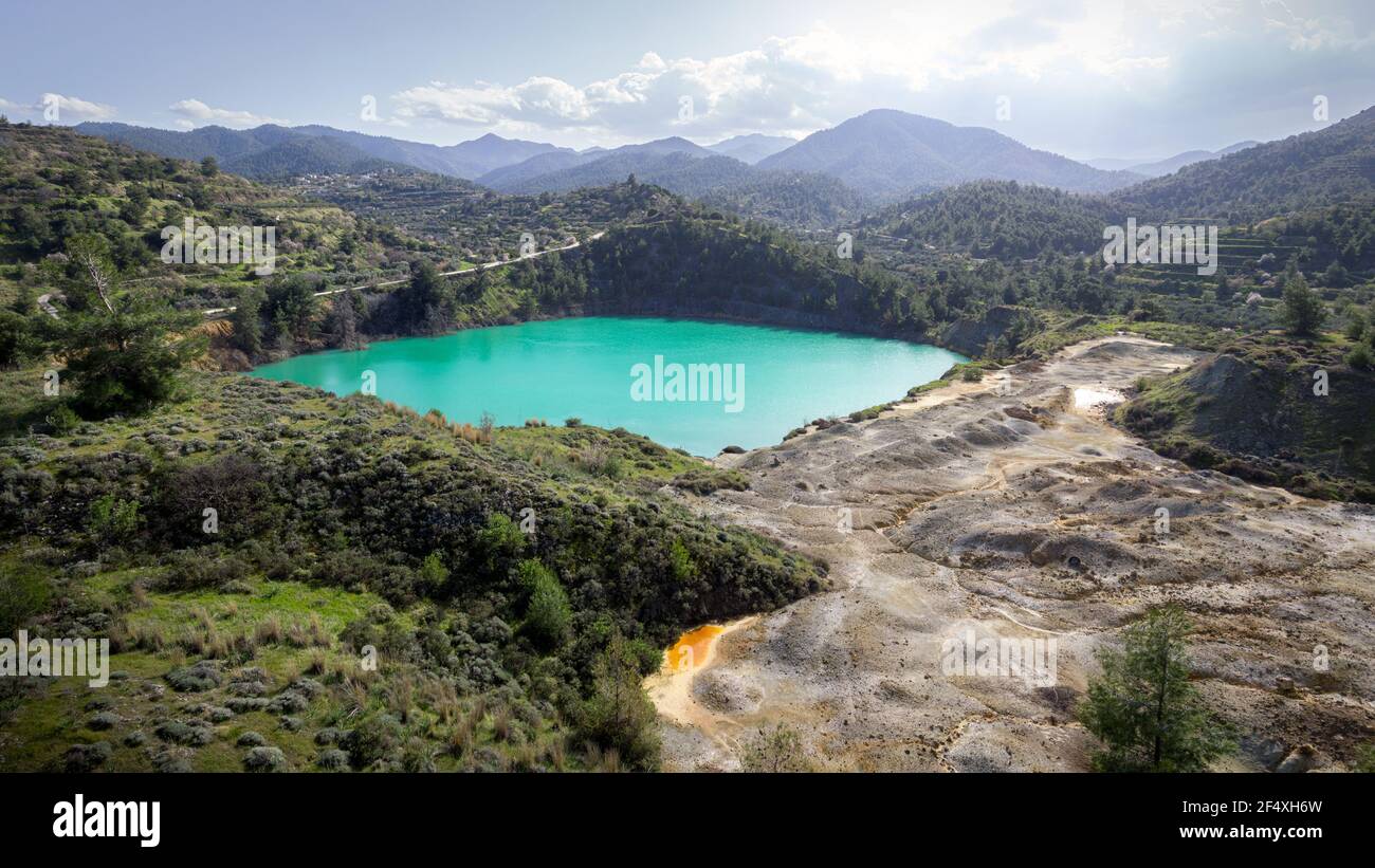 Aerial view of abandoned open pit Memi mine in Xyliatos, Cyprus. This area is rich with copper and sulphide deposits which gives the lake its unusual Stock Photo