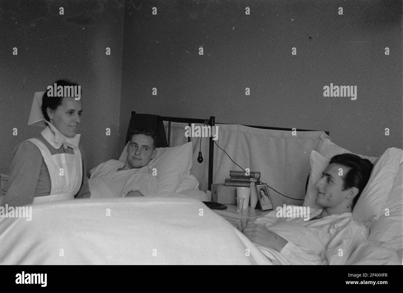 Second World War. Lazarett (probably in Holland). Two wounded relatives of  the German Wehrmacht in hospital beds. Next to it a nurse Stock Photo -  Alamy