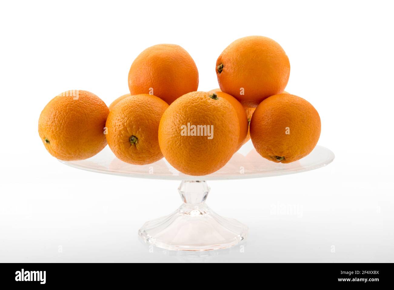 oranges from sicily on transparent glass raised plate isolated on white Stock Photo