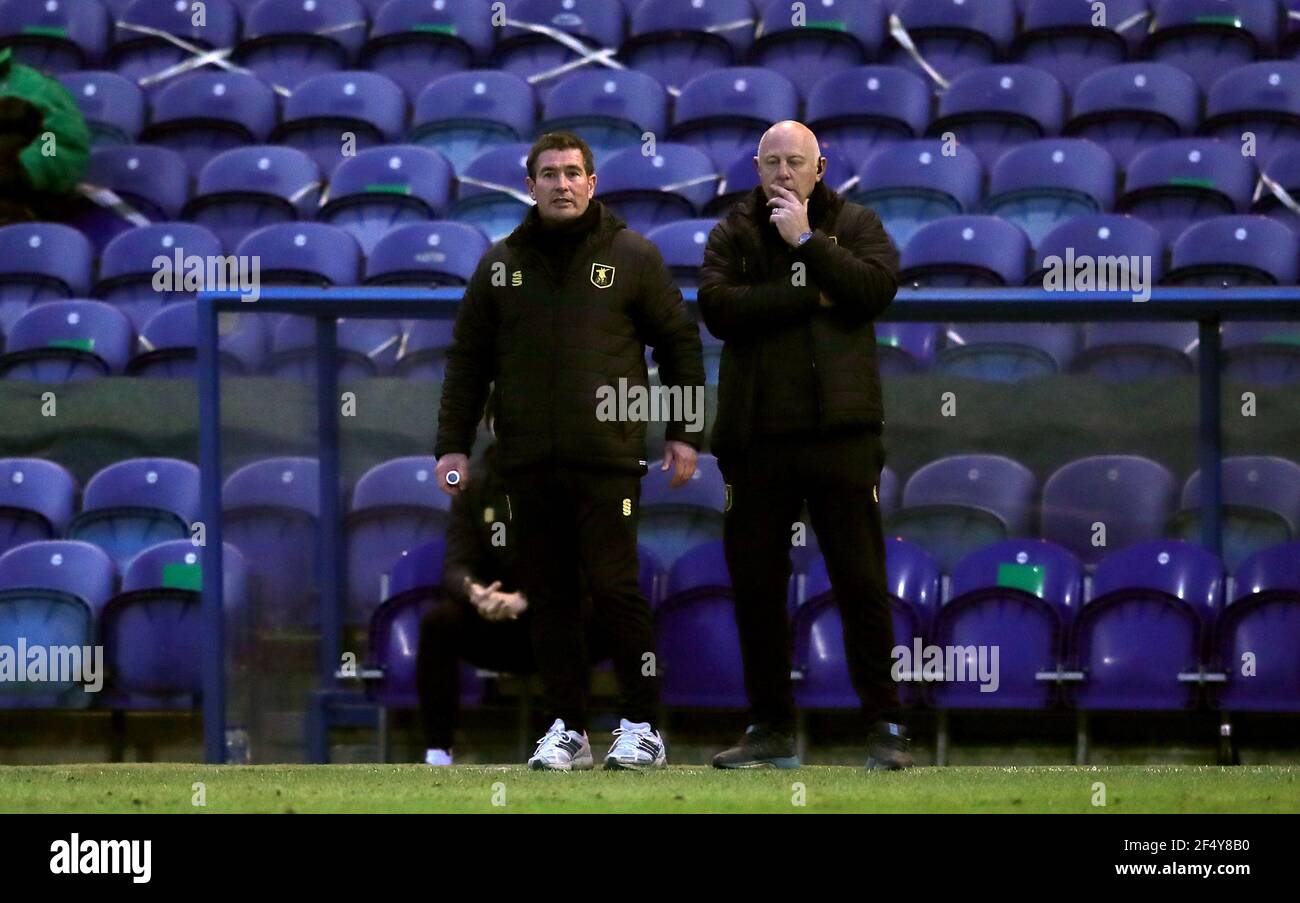 Mansfield Town manager Nigel Clough (left) watches from the touchline during the Sky Bet League Two match at the One Call Stadium, Mansfield. Picture date: Tuesday March 23, 2021. Stock Photo